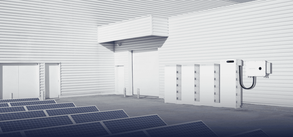 Sigenergy SigenStack commercial battery storage beside a building and solar panels