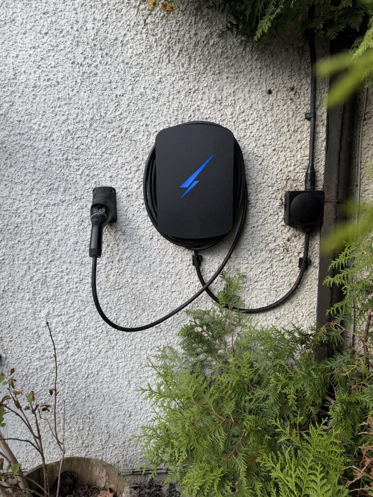 Black Hypervolt Home 3 Pro EV charger installed on an exterior wall in Corstorphine, Edinburgh, replacing a faulty Tesla Wall Charger.