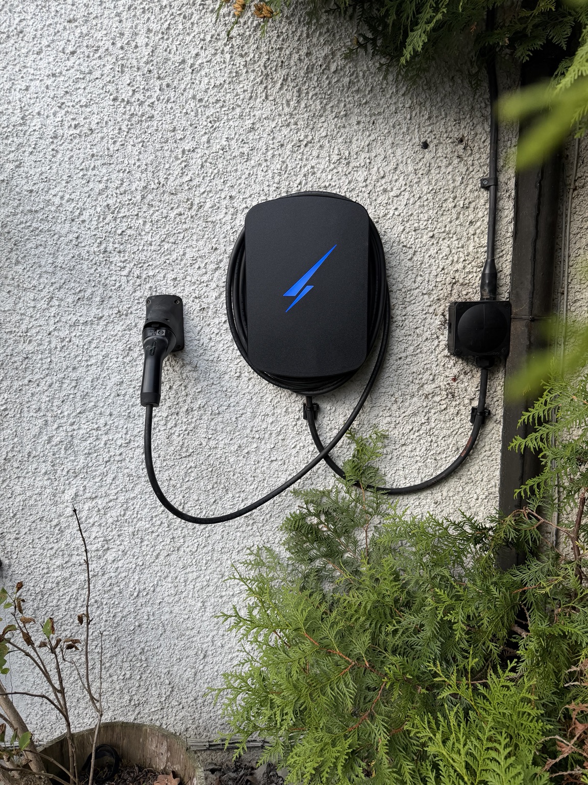 Black Hypervolt Home 3 Pro EV charger installed on an exterior wall in Corstorphine, Edinburgh, replacing a faulty Tesla Wall Charger.