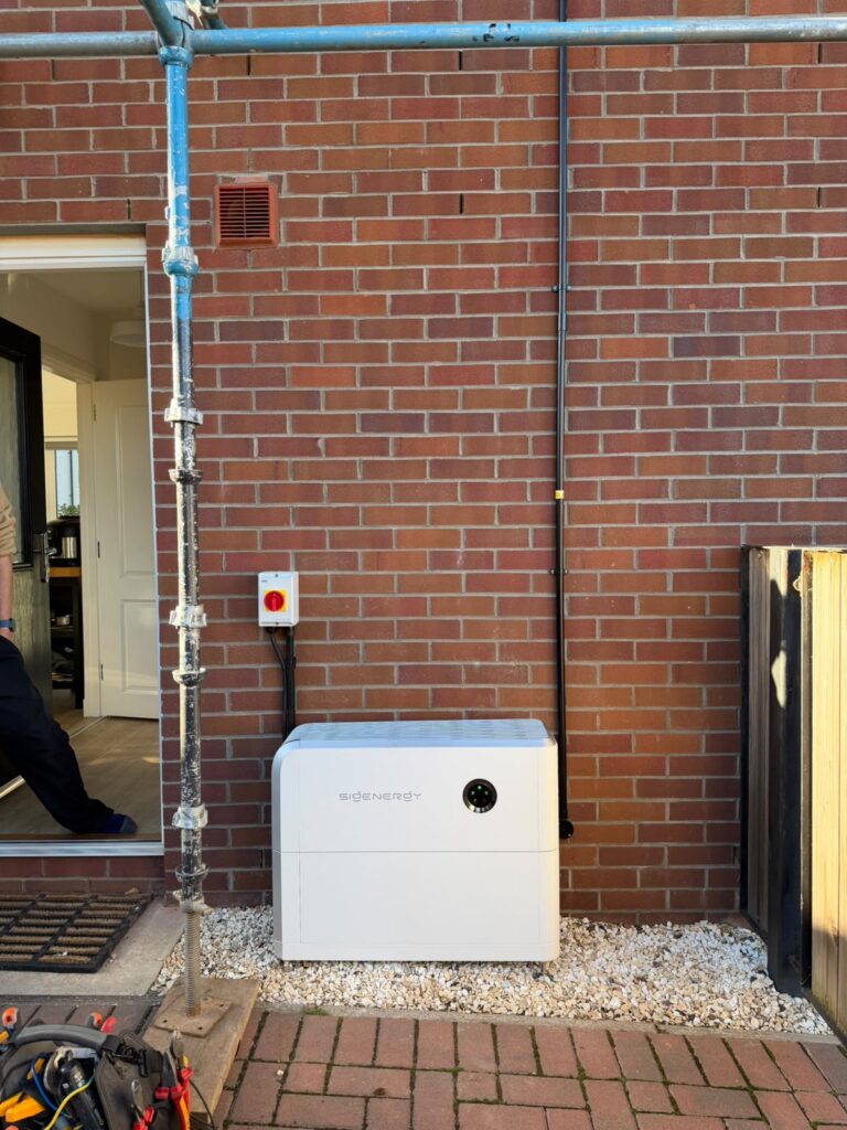 Sigenergy hybrid inverter and battery installed against an external brick wall as part of an AIKO solar panel upgrade